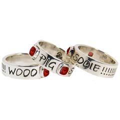 Woo Pig Sooie band ring with red stones.                                                                                                                                                                                                                  