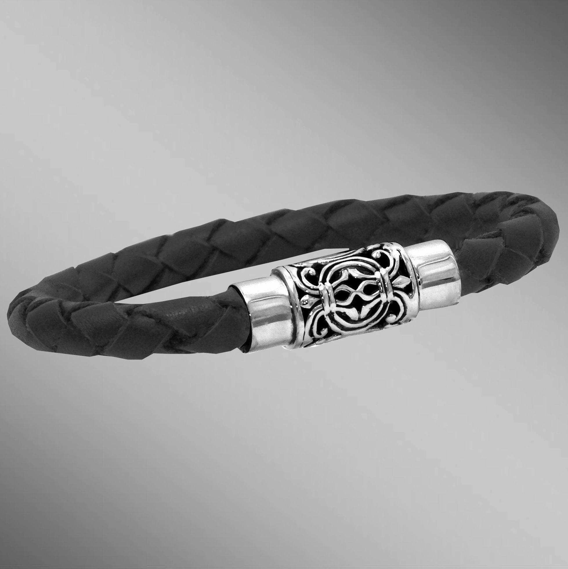 Silver fleur-de-lis clasp braided leather bracelet.  Arista.                                                                                                                                                                                              