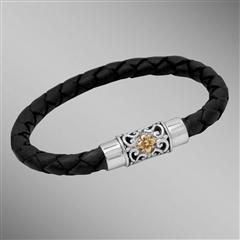 Black woven leather bracelet with gold flower on silver clasp.  Arista.                                                                                                                                                                                   