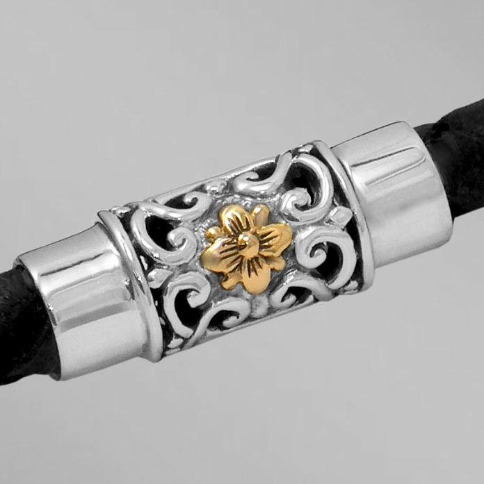 Sterling silver magnetic clasp with gold flower on braided leather bracelet.  Arista.                                                                                                                                                                     