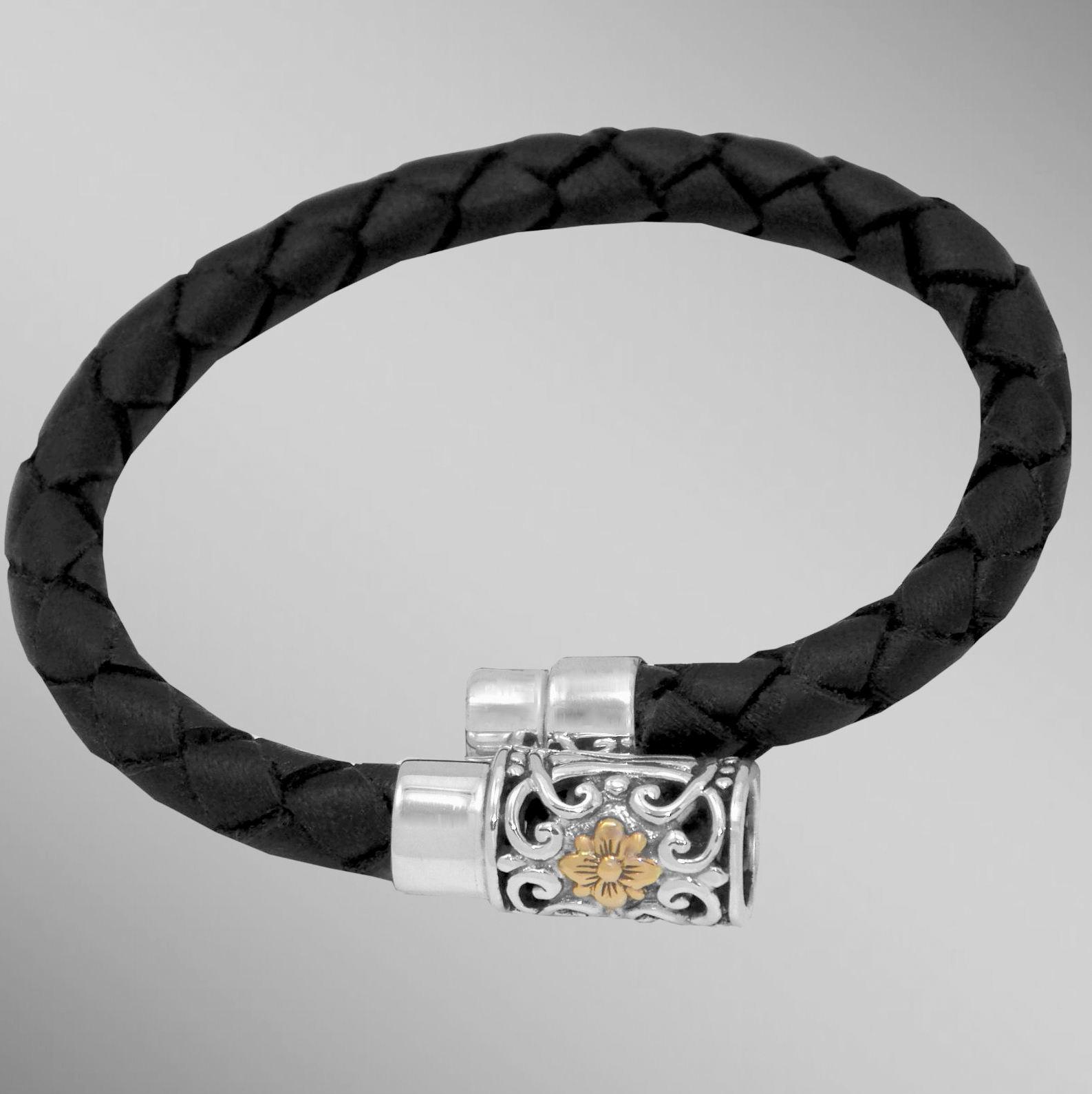 Black braided leather bracelet with silver and gold magnetic clasp.                                                                                                                                                                                       