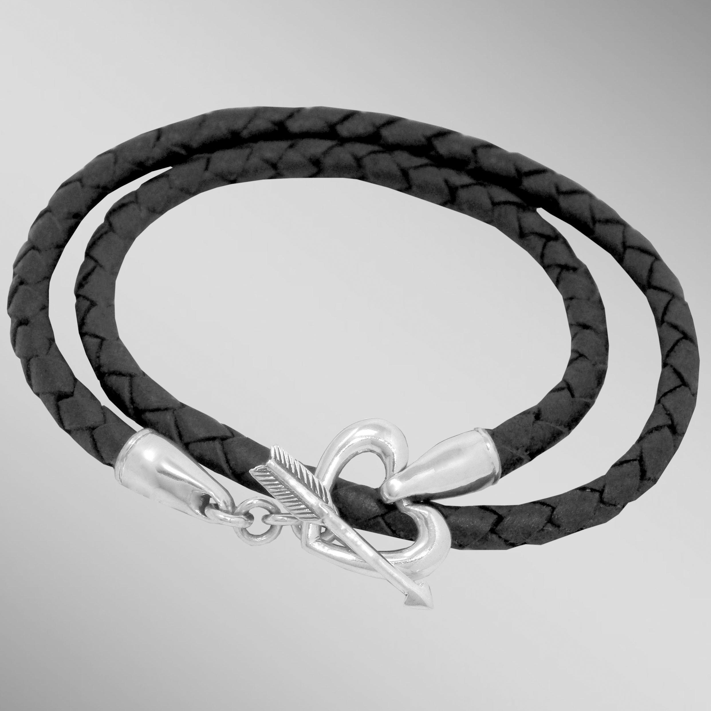 Black braided leather wrap bracelet with silver heart & arrow toggle clasp.  Arista.                                                                                                                                                                      