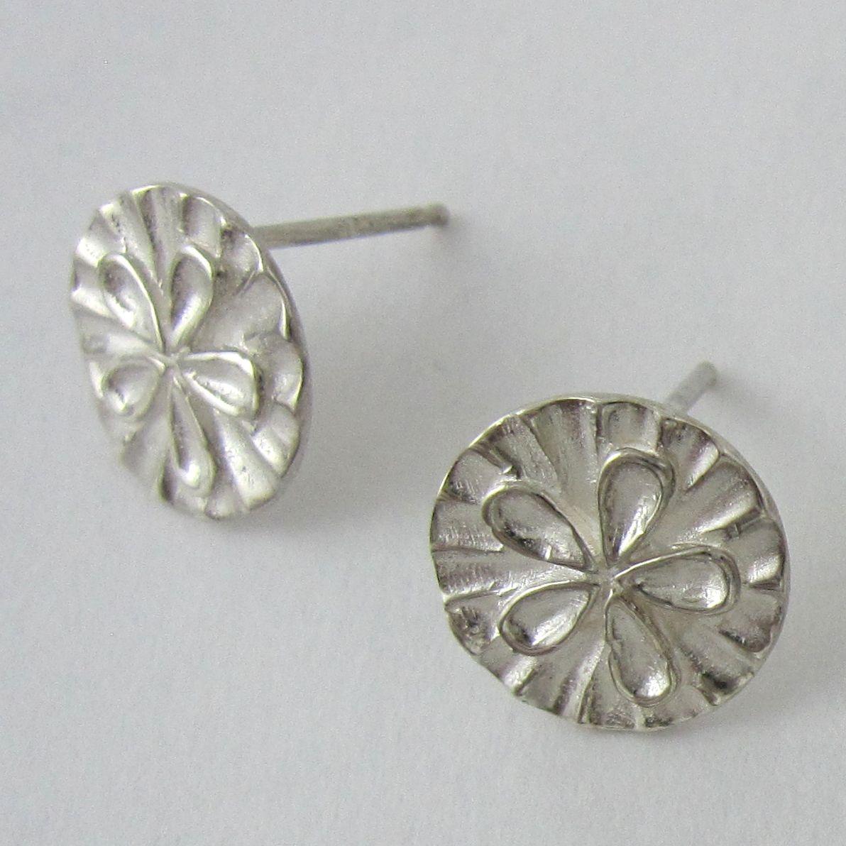 Sterling silver sand dollar stud earrings.                                                                                                                                                                                                                