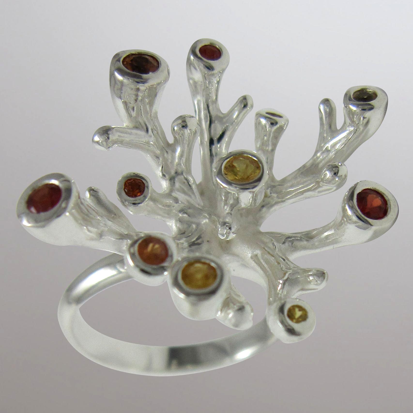 silver coral ring with fancy sapphires.                                                                                                                                                                                                                   