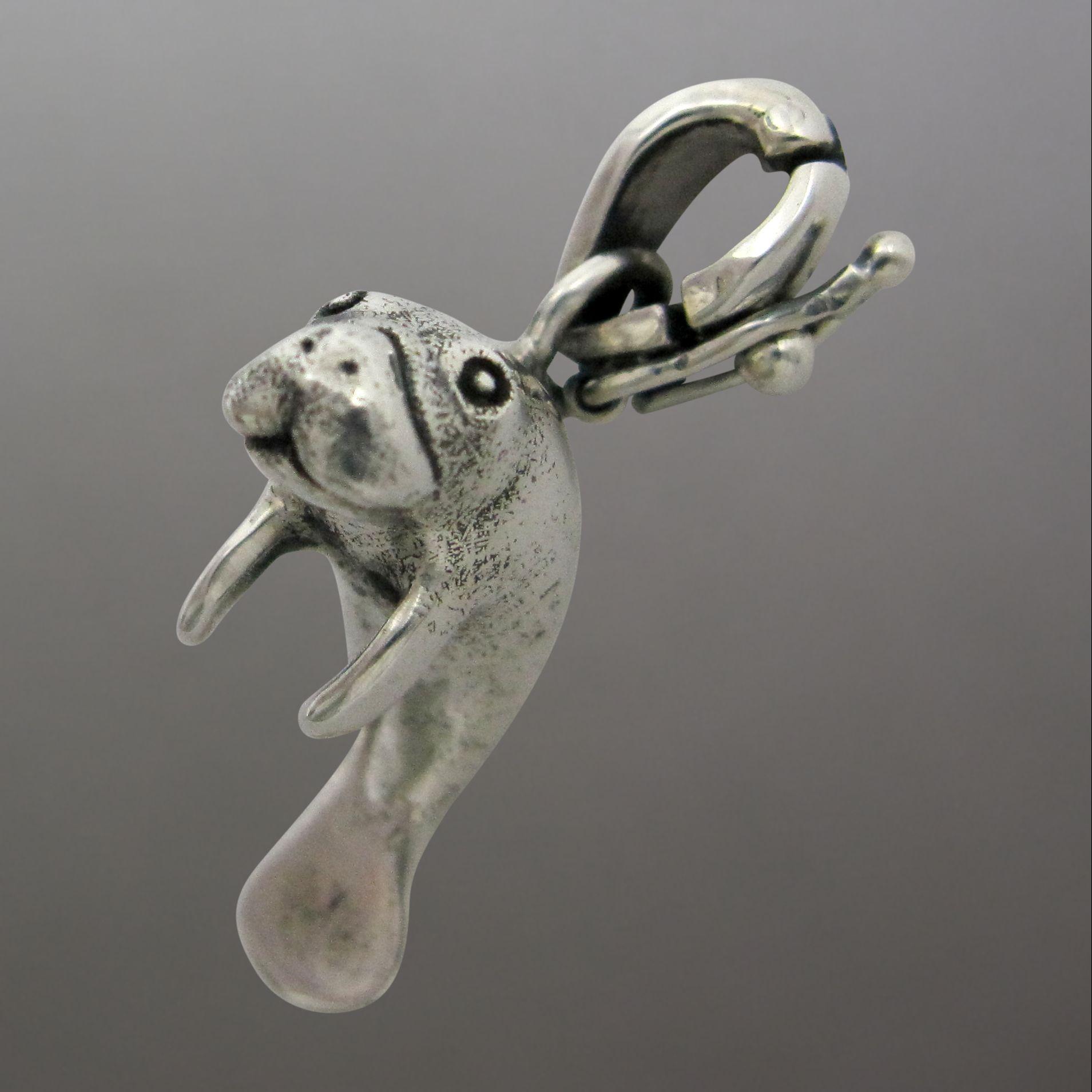 Silver manatee pendant charm.                                                                                                                                                                                                                             