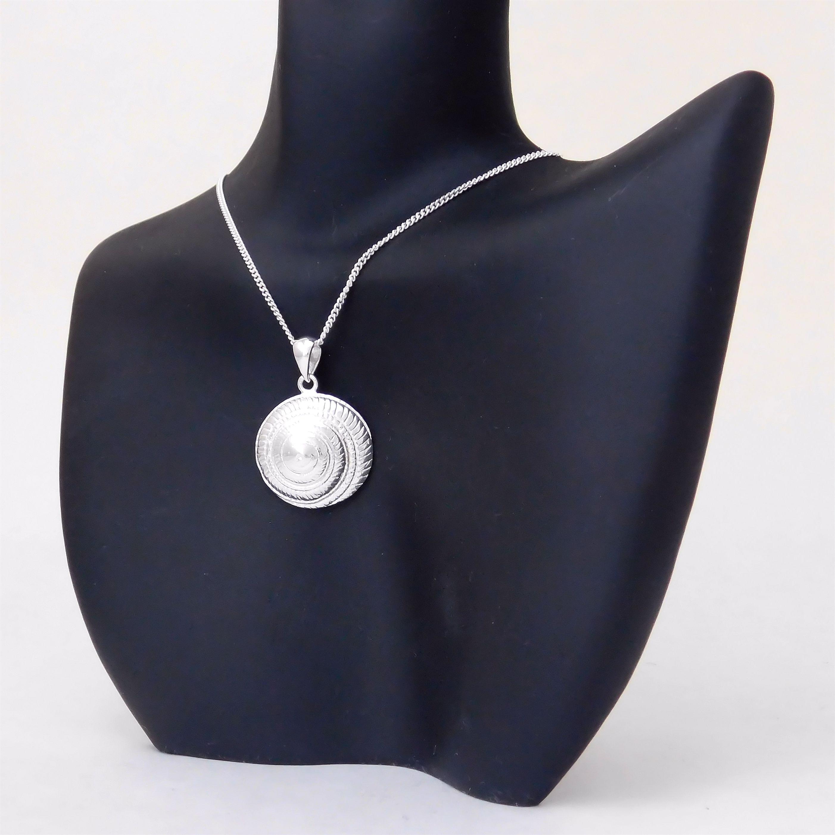 Sterling silver hypnotic spiral moon shell pendant.                                                                                                                                                                                                       