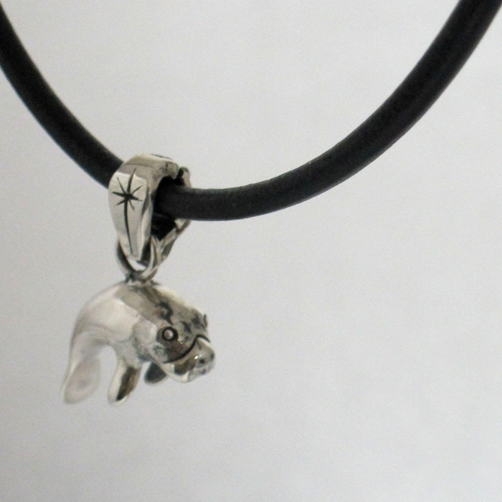 Manatee necklace with leather cord and silver pendant.                                                                                                                                                                                                    