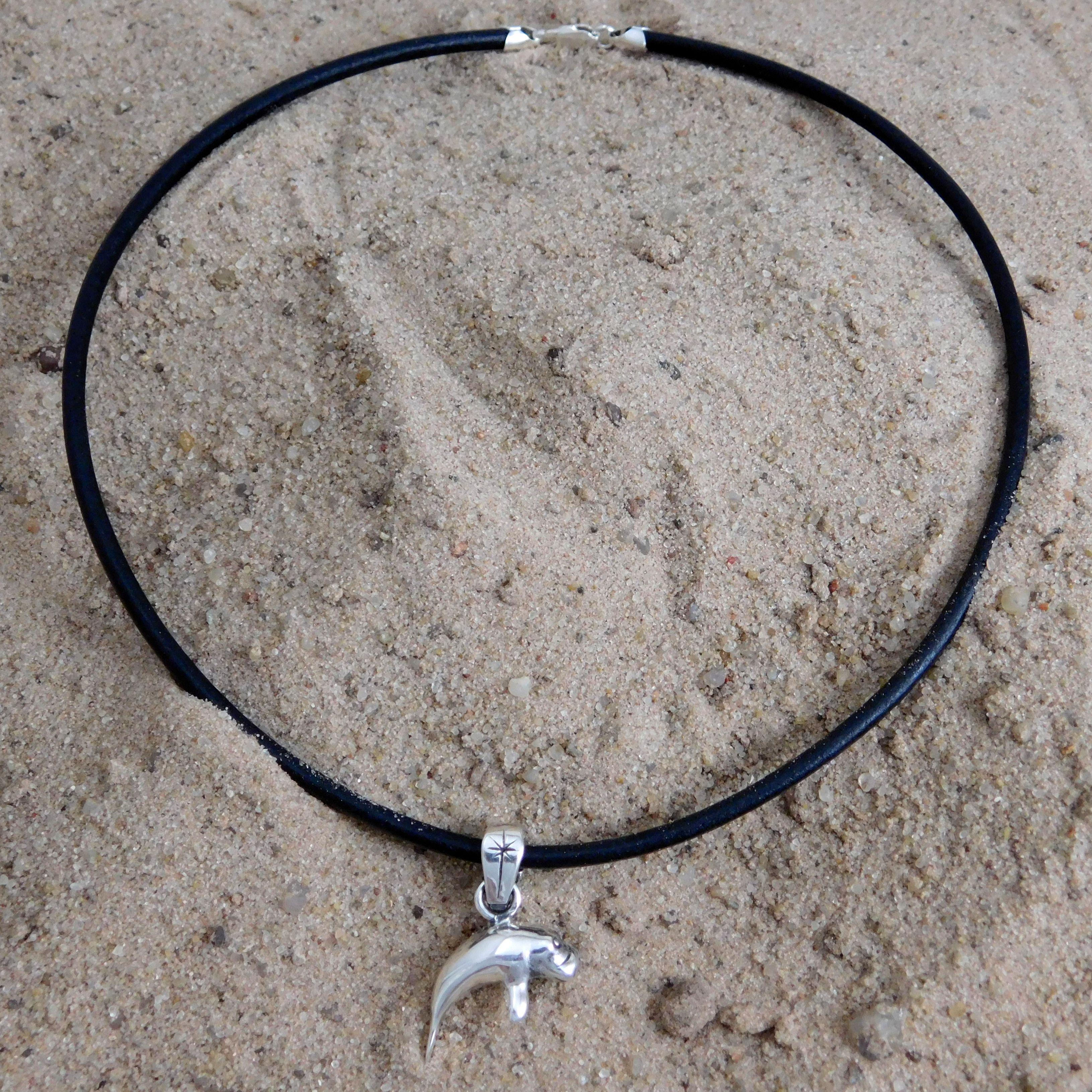 Black manatee necklace.                                                                                                                                                                                                                                   