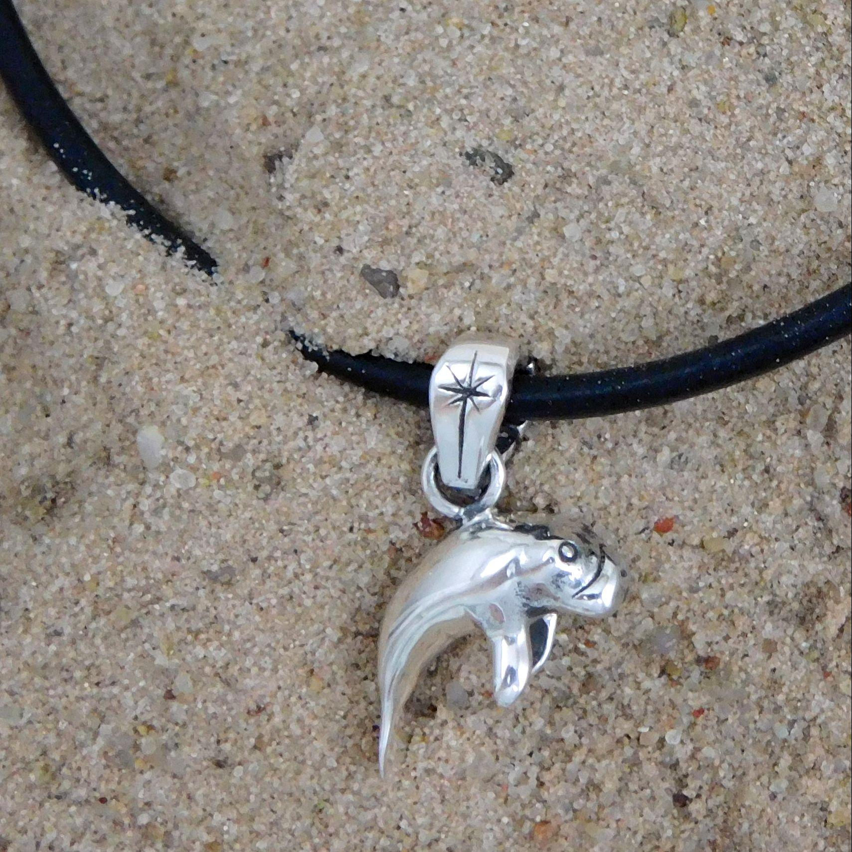 Sterling silver manatee pendant on cord necklace.                                                                                                                                                                                                         