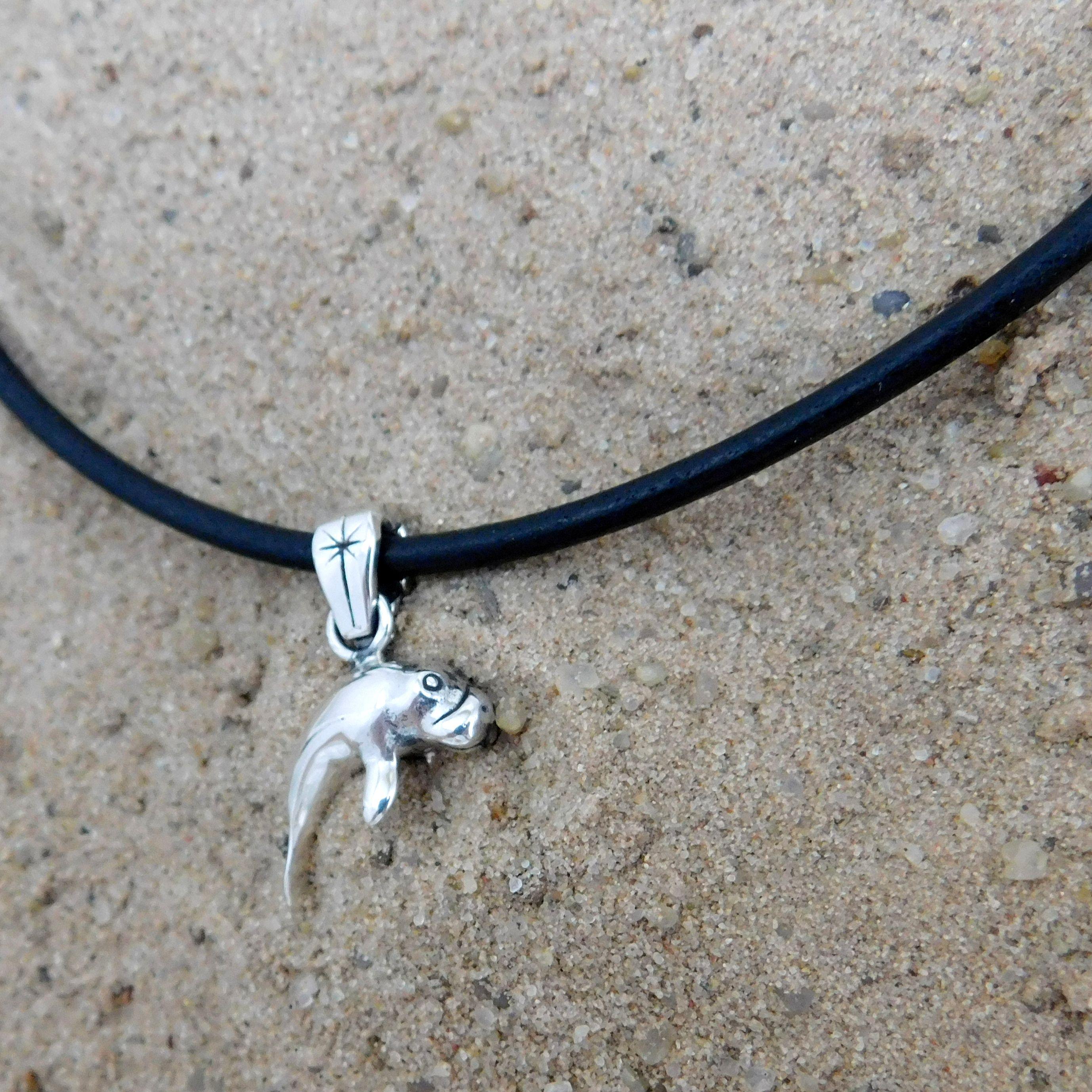 Silver and leather manatee necklace.                                                                                                                                                                                                                      