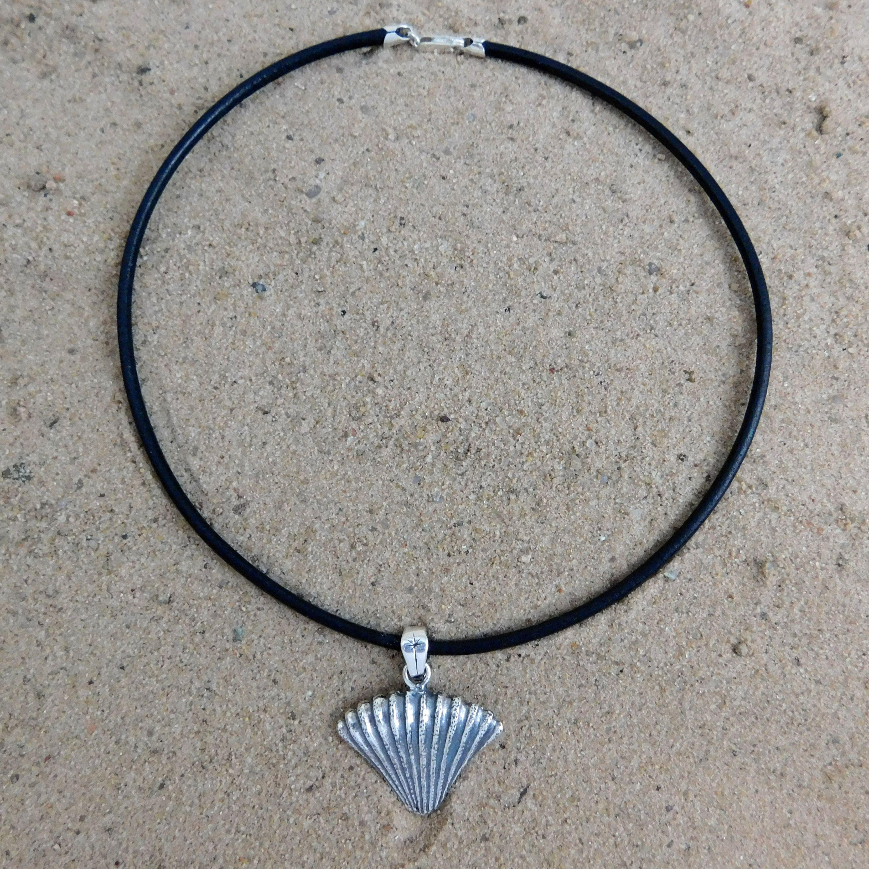 Black choker with sterling silver shell drop.                                                                                                                                                                                                             